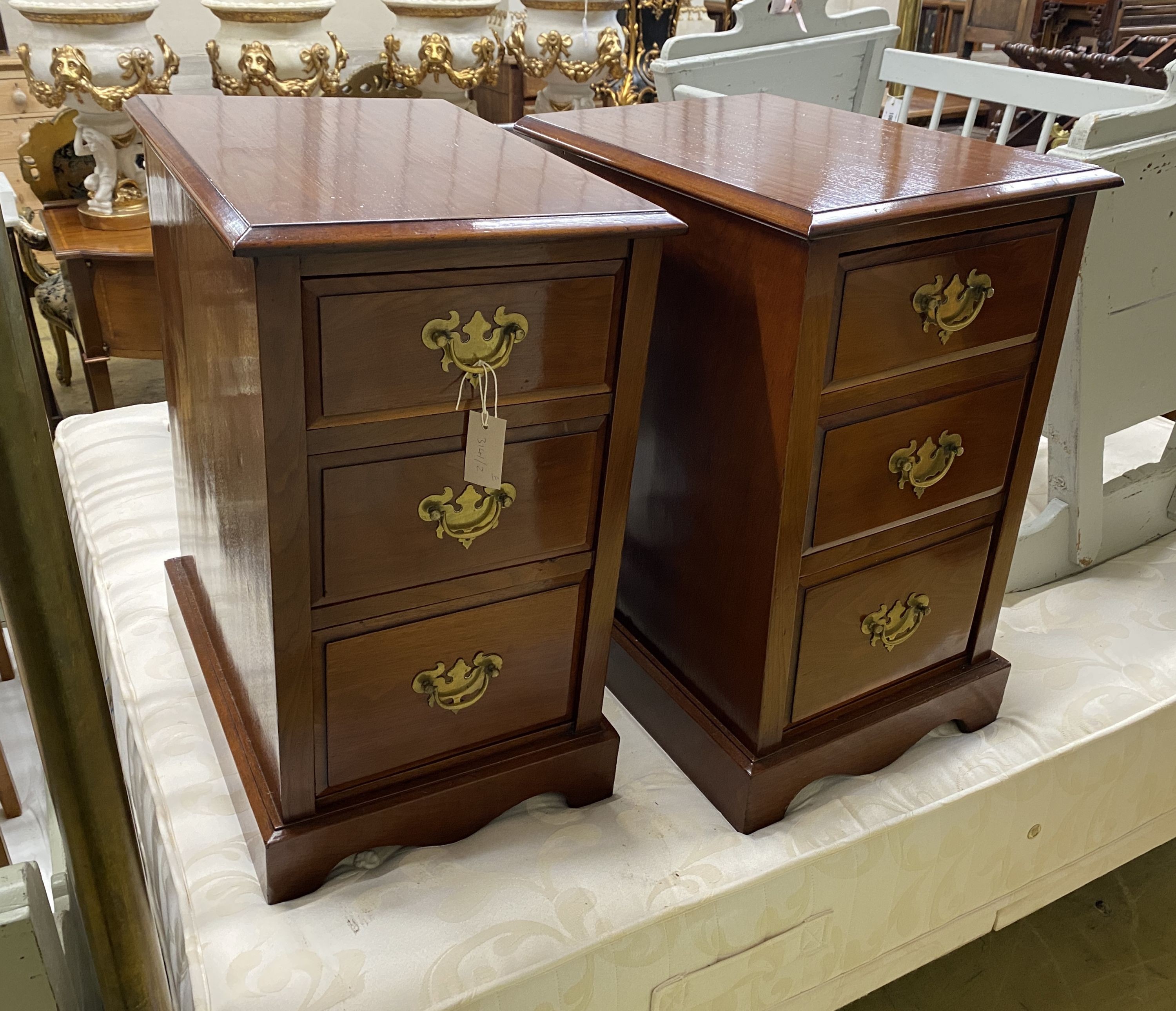 A pair of Edwardian walnut three drawer bedside chests, adapted, width 38cm, depth 54cm, height 65cm